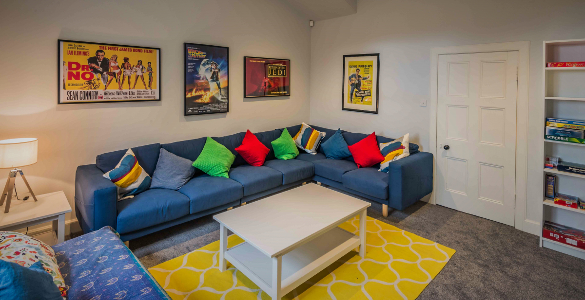 The large TV and games room. There's a wall mounted flat screen TV and DVD player.